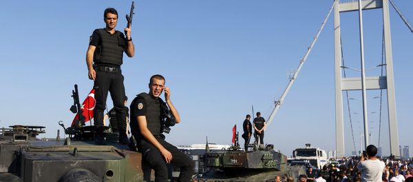 Policemen stand atop military armored vehicles after troops involved in the coup surrendered on the Bosphorus Bridge in Istanbul, Turkey July 16, 2016. Policemen stand atop military armored vehicles after troops involved in the coup surrendered on the Bosphorus Bridge in Istanbul, Turkey July 16, 2016. - Sputnik International