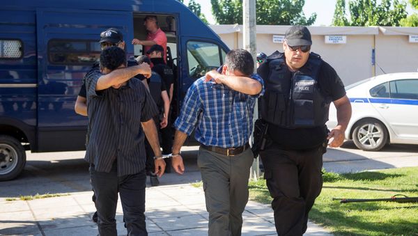 Two of the eight Turkish soldiers who fled to Greece in a helicopter and requested political asylum after a failed military coup against the government, are brought to prosecutor by two policemen in the northern Greek city of Alexandroupolis, Greece, July 17, 2016. Two of the eight Turkish soldiers who fled to Greece in a helicopter and requested political asylum after a failed military coup against the government, are brought to prosecutor by two policemen in the northern Greek city of Alexandroupolis, Greece, July 17, 2016. - Sputnik International