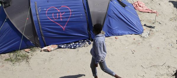 A heart and UK symbol are marked on the side of a tent as a migrant walks in the make-shift camp, called the jungle, in Calais, France, after Britain's referendum results to leave the European Union were announced June 24, 2016. A heart and UK symbol are marked on the side of a tent as a migrant walks in the make-shift camp, called the jungle, in Calais, France, after Britain's referendum results to leave the European Union were announced June 24, 2016. - Sputnik International