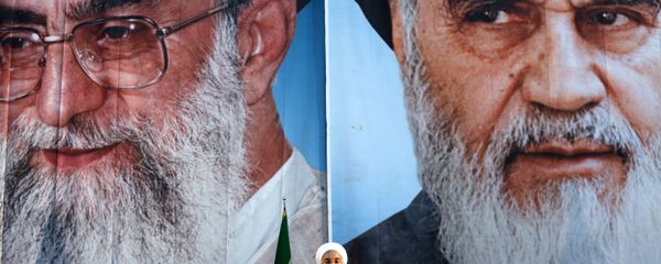 Iranian President Hassan Rouhani delivers a speech under portraits of Iran's supreme leader, Ayatollah Ali Khamenei (L) and Iran's founder of the Islamic Republic, Ayatollah Ruhollah Khomeini (R), on the eve of the 25th anniversary of the Islamic revolutionary leader Ayatollah Ruhollah Khomeini's death, at his mausoleum in a suburb of Tehran - Sputnik International