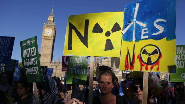 Demonstrators hold placards as they attend an anti-war and anti-trident demonstration near the Houses of Parliament in central London on July 18, 2016 - Sputnik International