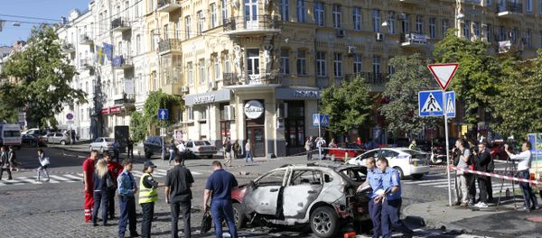 Forensic experts examine the wreckage of a burned car in Kiev, Ukraine, Wednesday, July 20, 2016 Forensic experts examine the wreckage of a burned car in Kiev, Ukraine, Wednesday, July 20, 2016 - Sputnik International