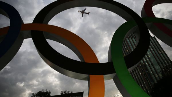 An airplane flies past Olympic rings placed at the entrance of office building ahead of the Rio 2016 Olympic Games, in Sao Paulo, Brazil, July 19, 2016 An airplane flies past Olympic rings placed at the entrance of office building ahead of the Rio 2016 Olympic Games, in Sao Paulo, Brazil, July 19, 2016 - Sputnik International