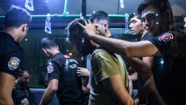 A file photo showing Turkish anti riot police officers detain a Turkish soldier who allegedly took part in a military coup as they are leaving in a bus the courthouse at Bakirkoy district in Istanbul on July 16, 2016 - Sputnik International