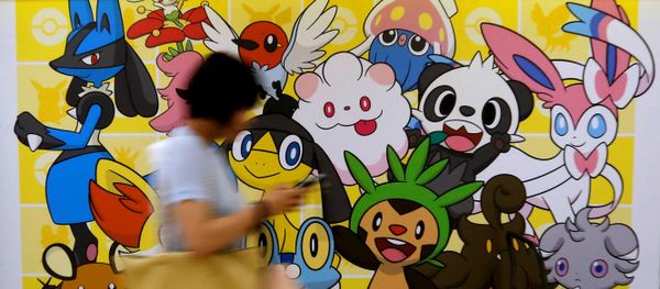 A woman using a mobile phone walks past a shop selling Pokemon goods in Tokyo, Japan July 20, 2016. A woman using a mobile phone walks past a shop selling Pokemon goods in Tokyo, Japan July 20, 2016. - Sputnik International