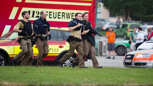 Police walks near a shopping mall amid a shooting on July 22, 2016 in Munich Police walks near a shopping mall amid a shooting on July 22, 2016 in Munich - Sputnik International