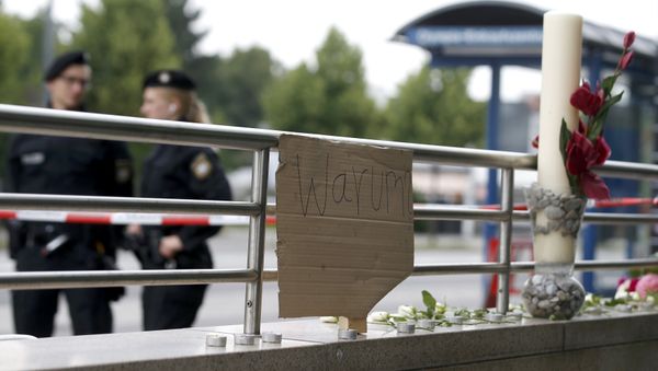 A sign reading 'Why' and flowers are placed on on a wall near the Olympia shopping mall, where yesterday's shooting rampage started, in Munich, Germany July 23, 2016. A sign reading 'Why' and flowers are placed on on a wall near the Olympia shopping mall, where yesterday's shooting rampage started, in Munich, Germany July 23, 2016. - Sputnik International