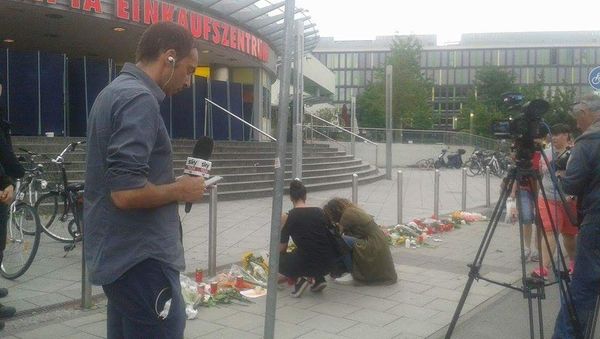 Flowers outside the Olympia shopping mall, where yesterday's shooting rampage started, in Munich, Germany Flowers outside the Olympia shopping mall, where yesterday's shooting rampage started, in Munich, Germany - Sputnik International