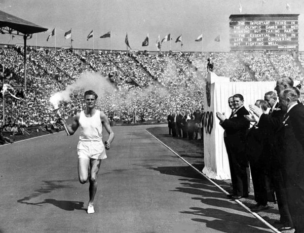 British athlete John Mark holds the Olympic Flame aloft as he makes his circuit of the Olympic track during the opening ceremony of the XIV Olympiad, in Wembley Stadium, London, July 29, 1948. (File) British athlete John Mark holds the Olympic Flame aloft as he makes his circuit of the Olympic track during the opening ceremony of the XIV Olympiad, in Wembley Stadium, London, July 29, 1948. (File) - Sputnik International