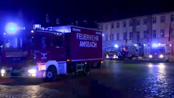 In this image taken from video fire trucks and ambulances stand in the city center of Ansbach near Nuremberg, southern Germany, Monday morning, July 25, 2016, after a man was killed when an explosive device he was believed to be carrying went off near an open-air music festival, injuring 12 others. In this image taken from video fire trucks and ambulances stand in the city center of Ansbach near Nuremberg, southern Germany, Monday morning, July 25, 2016, after a man was killed when an explosive device he was believed to be carrying went off near an open-air music festival, injuring 12 others. - Sputnik International