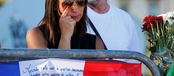 A woman reacts near flowers and flags placed in tribute to victims, two days after an attack by the driver of a heavy truck who ran into a crowd on Bastille Day killing scores and injuring as many on the Promenade des Anglais, in Nice, France, July 16, 2016. A woman reacts near flowers and flags placed in tribute to victims, two days after an attack by the driver of a heavy truck who ran into a crowd on Bastille Day killing scores and injuring as many on the Promenade des Anglais, in Nice, France, July 16, 2016. - Sputnik International