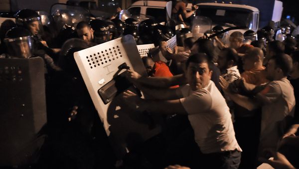 Prostesters clash with the police outside the seized road police building in Yerevan Prostesters clash with the police outside the seized road police building in Yerevan - Sputnik International