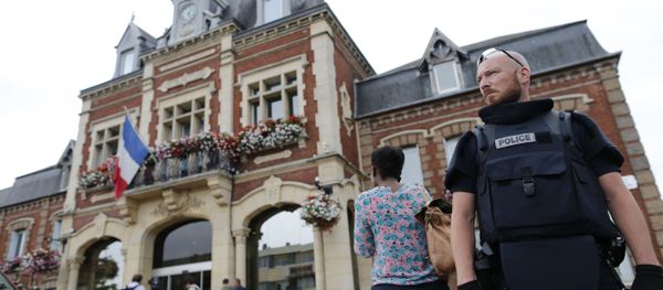 A French police officer stands guard by Saint-Etienne-du-Rouvray's city hall following a hostage-taking at a church in Saint-Etienne-du-Rouvray, northern France A French police officer stands guard by Saint-Etienne-du-Rouvray's city hall following a hostage-taking at a church in Saint-Etienne-du-Rouvray, northern France - Sputnik International