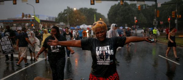 Black Lives Matter activists react to heavy rain fall as they gather to protest outside the site of the 2016 Democratic National Convention in Philadelphia, Pennsylvania July 25, 2016. Black Lives Matter activists react to heavy rain fall as they gather to protest outside the site of the 2016 Democratic National Convention in Philadelphia, Pennsylvania July 25, 2016. - Sputnik International