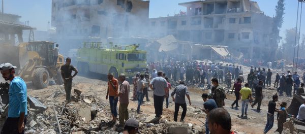Smoke rises while people gather at a damaged site after two bomb blasts claimed by Islamic State hit the northeastern Syrian city of Qamishli near the Turkish border, Syria July 27, 2016 Smoke rises while people gather at a damaged site after two bomb blasts claimed by Islamic State hit the northeastern Syrian city of Qamishli near the Turkish border, Syria July 27, 2016 - Sputnik International