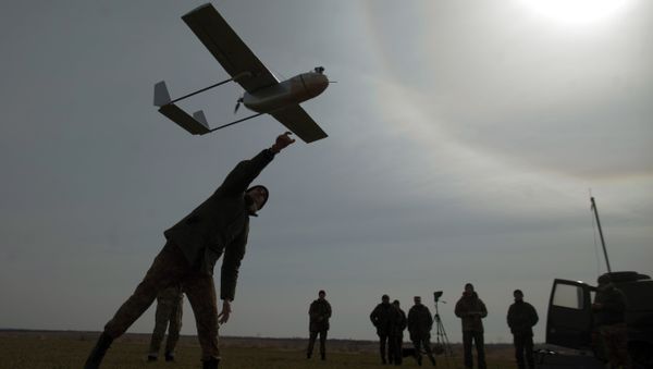 A serviceman launches an unmanned reconnaissance aircraft at the position of the Ukrainian forces near eastern Ukrainian city of Lysychansk, Lugansk region on March 24, 2015 A serviceman launches an unmanned reconnaissance aircraft at the position of the Ukrainian forces near eastern Ukrainian city of Lysychansk, Lugansk region on March 24, 2015 - Sputnik International