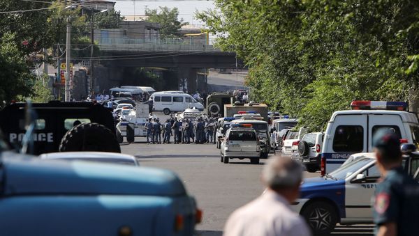 Policemen block a street after group of armed men seized a police station along with an unknown number of hostages, according the country's security service, in Yerevan, Armenia - Sputnik International