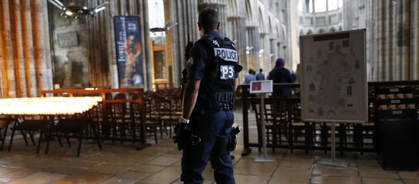 A policeman stands guard while people arrive for a Mass at the Rouen Cathedral, on July 27, 2016 in Rouen, to pay tribute to the priest Jacques Hamel, killed on July 26 in a church of Saint-Etienne-du-Rouvray during a hostage-taking claimed by Islamic State group A policeman stands guard while people arrive for a Mass at the Rouen Cathedral, on July 27, 2016 in Rouen, to pay tribute to the priest Jacques Hamel, killed on July 26 in a church of Saint-Etienne-du-Rouvray during a hostage-taking claimed by Islamic State group - Sputnik International