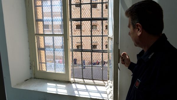 A guard looks at prisoner from a window of Regina Coeli prison in Rome on May 30, 2014 A guard looks at prisoner from a window of Regina Coeli prison in Rome on May 30, 2014 - Sputnik International