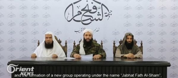 A still image taken on July 29, 2016 from an undated video shows Abu Mohamad al-Golani (C), the leader of the Syrian Islamist rebel group Jabhat Fateh al-Sham, formely known as Nusra Front, delivering a statemtent at an unknown location A still image taken on July 29, 2016 from an undated video shows Abu Mohamad al-Golani (C), the leader of the Syrian Islamist rebel group Jabhat Fateh al-Sham, formely known as Nusra Front, delivering a statemtent at an unknown location - Sputnik International