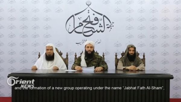A still image taken on July 29, 2016 from an undated video shows Abu Mohamad al-Golani (C), the leader of the Syrian Islamist rebel group Jabhat Fateh al-Sham, formely known as Nusra Front, delivering a statemtent at an unknown location - Sputnik International