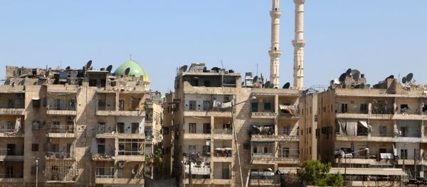 Buildings are pictured near the road, which was believed to be used by civilians to access one of the safe exit points opened for civilians intending to leave rebel-held areas, in Aleppo's Bustan al-Qasr, Syria July 29, 2016 - Sputnik International