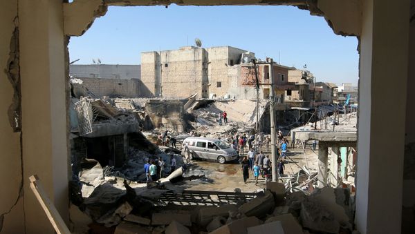 People inspect a site hit by airstrikes in the rebel held town of Atareb in Aleppo province, Syria, July 25, 2016 - Sputnik International