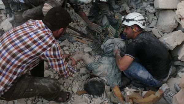 Syrian civil defence volunteers remove the body of a man from the rubble of destroyed buildings following reported airstrikes on April 27, 2016 in the rebel-held eastern neighbourhood of Bab al-Nayrab in the city of Aleppo Syrian civil defence volunteers remove the body of a man from the rubble of destroyed buildings following reported airstrikes on April 27, 2016 in the rebel-held eastern neighbourhood of Bab al-Nayrab in the city of Aleppo - Sputnik International
