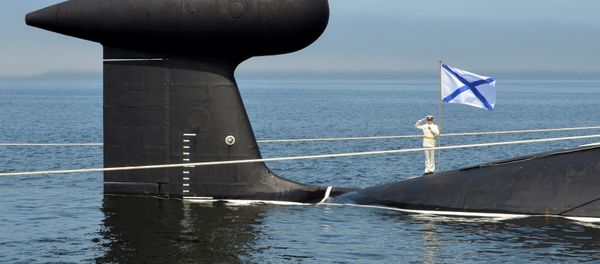 A sailor salutes as he stands on the Kuzbass nuclear submarine during a rehearsal for the Navy Day parade in the far eastern port of Vladivostok, Russia A sailor salutes as he stands on the Kuzbass nuclear submarine during a rehearsal for the Navy Day parade in the far eastern port of Vladivostok, Russia - Sputnik International