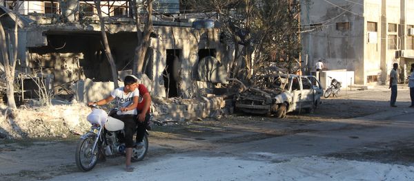 People inspect the damage as they stand near a Save the Children sponsored maternity hospital after an airstrike in the rebel-controlled town of Kafer Takhareem in Idlib province, Syria People inspect the damage as they stand near a Save the Children sponsored maternity hospital after an airstrike in the rebel-controlled town of Kafer Takhareem in Idlib province, Syria - Sputnik International