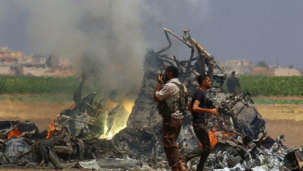 Men inspect the wreckage of a Russian helicopter that had been shot down in the north of Syria's rebel-held Idlib province, Syria - Sputnik International