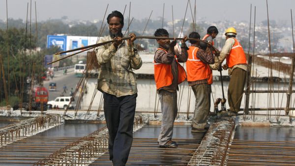 Indian workers carry metal rods on an overpass bridge in Jammu, India Indian workers carry metal rods on an overpass bridge in Jammu, India - Sputnik International