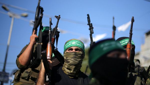 Hamas militants hold weapons as they celebrate the release of Palestinian prisoner Mohammed al-Bashiti, who served 12 years in an Israeli jail after he was convicted of being a member of Hamas' armed wing, in Rafah in the southern Gaza Strip July 25, 2016 - Sputnik International
