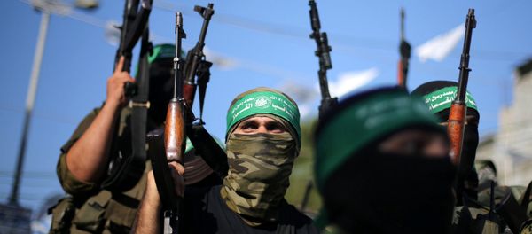 Hamas militants hold weapons as they celebrate the release of Palestinian prisoner Mohammed al-Bashiti, who served 12 years in an Israeli jail after he was convicted of being a member of Hamas' armed wing, in Rafah in the southern Gaza Strip July 25, 2016 - Sputnik International
