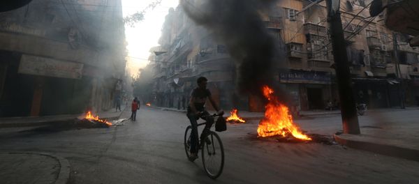 A man rides a bicycle past burning tyres, which activists said are used to create smoke cover from warplanes, in Aleppo, Syria August 1, 2016 A man rides a bicycle past burning tyres, which activists said are used to create smoke cover from warplanes, in Aleppo, Syria August 1, 2016 - Sputnik International