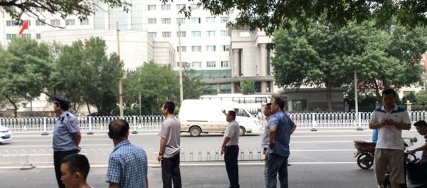 Chinese policemen in plain clothes stand as they stop journalists from taking pictures and video footage in front of the Number 2 Intermediate People's Court in Tianjin on August 4, 2016 Chinese policemen in plain clothes stand as they stop journalists from taking pictures and video footage in front of the Number 2 Intermediate People's Court in Tianjin on August 4, 2016 - Sputnik International
