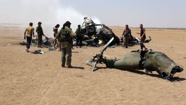 A picture taken on August 1, 2016 shows Syrian rebels gathering around the wreckage of a Russian Mi-8 military transport helicopter after it was shot down along the administrative border between Idlib province, northwestern Syria and neighbouring Aleppo A picture taken on August 1, 2016 shows Syrian rebels gathering around the wreckage of a Russian Mi-8 military transport helicopter after it was shot down along the administrative border between Idlib province, northwestern Syria and neighbouring Aleppo - Sputnik International