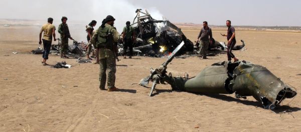 A picture taken on August 1, 2016 shows Syrian rebels gathering around the wreckage of a Russian Mi-8 military transport helicopter after it was shot down along the administrative border between Idlib province, northwestern Syria and neighbouring Aleppo A picture taken on August 1, 2016 shows Syrian rebels gathering around the wreckage of a Russian Mi-8 military transport helicopter after it was shot down along the administrative border between Idlib province, northwestern Syria and neighbouring Aleppo - Sputnik International