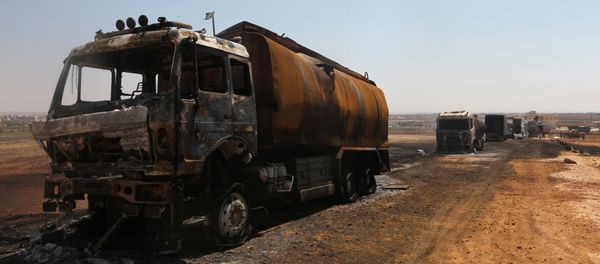 Damaged trucks are pictured after an airstrike on a truck parking lot in the rebel-held town of Atareb in Aleppo province, Syria August 3, 2016 - Sputnik International