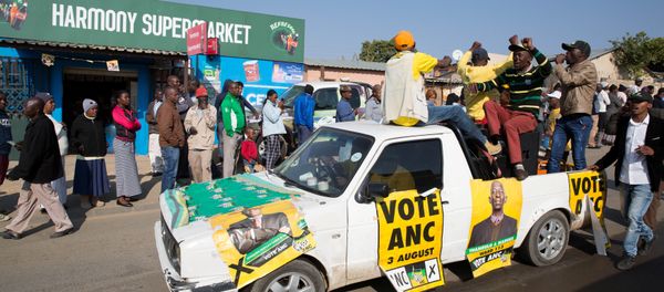 An ANC party vehicle appeals for votes as locals are seen outside a voting station during the Local Government elections in Diepsloot township, north of Johannesburg, South Africa - Sputnik International
