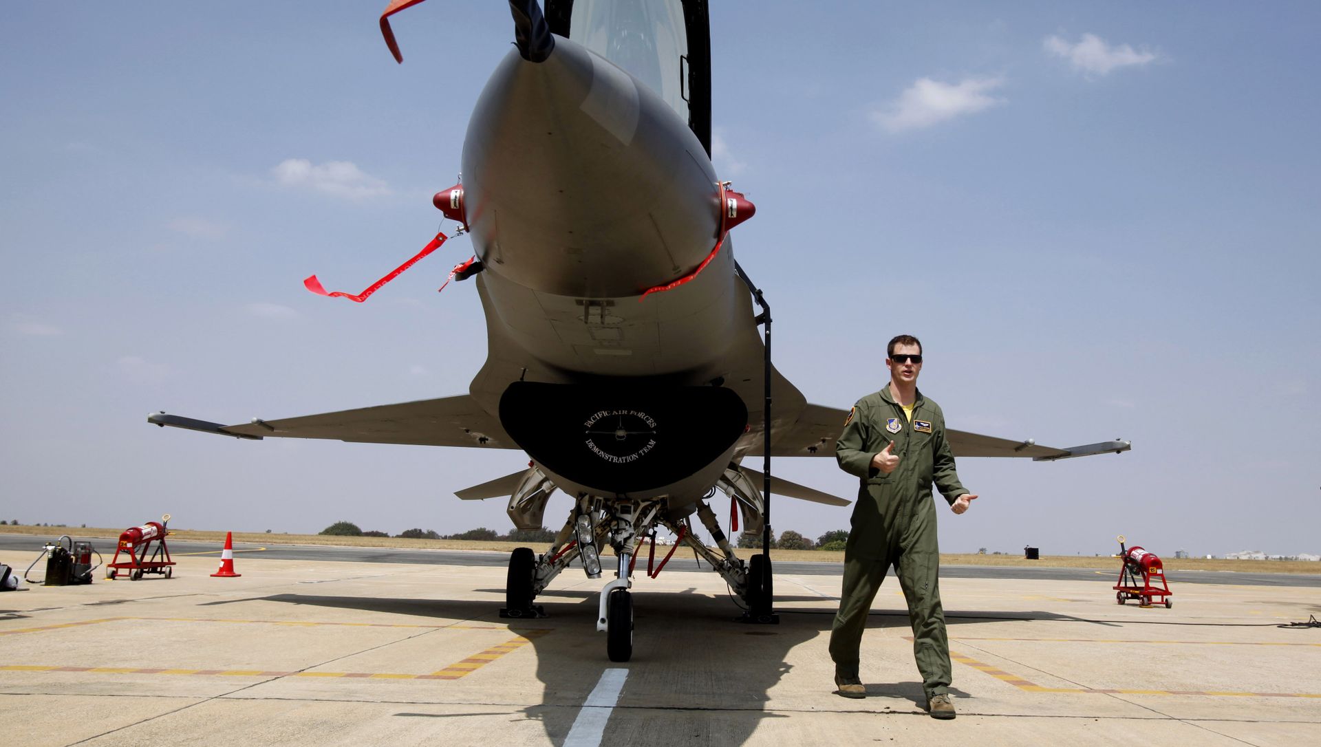 US Air Forces F-16 demonstration team pilot, Ryan Worrell from Iowa, walks past the F-16, a fighter aircraft, on display on the fourth day of the Aero India 2013 at Yelahanka air base in Bangalore, India, Saturday, Feb. 9, 2013 US Air Forces F-16 demonstration team pilot, Ryan Worrell from Iowa, walks past the F-16, a fighter aircraft, on display on the fourth day of the Aero India 2013 at Yelahanka air base in Bangalore, India, Saturday, Feb. 9, 2013 - Sputnik International, 1920, 10.04.2021
