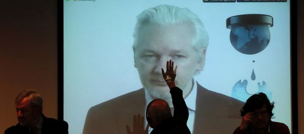 WikiLeaks founder Julian Assange appears on screen via video link during his participation as a guest panelist in an International Seminar on the 60th anniversary of the college of Journalists of Chile in Santiago, Chile, July 12, 2016 - Sputnik International