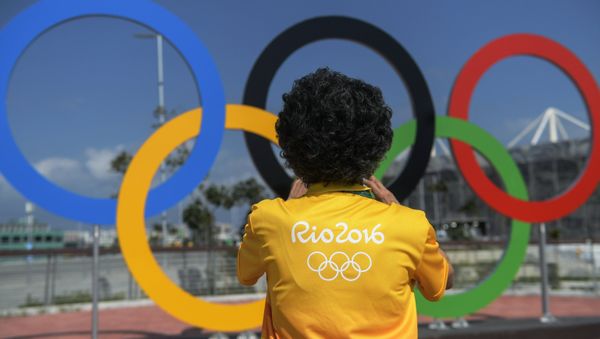 A man at the Olympic rings at the Olympic Park in Rio de Janeiro A man at the Olympic rings at the Olympic Park in Rio de Janeiro - Sputnik International