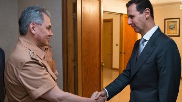 Russian Defense Minister Sergei Shoigu, left, and President of Syria Bashar al-Assad at a meeting in Syria Russian Defense Minister Sergei Shoigu, left, and President of Syria Bashar al-Assad at a meeting in Syria - Sputnik International