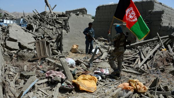 Afghan security force member walks holding the Afghan national flag after government forces took full control of a village from Islamic State (IS) fighters during a military operation in Kot District of eastern Nangarhar province (File) - Sputnik International