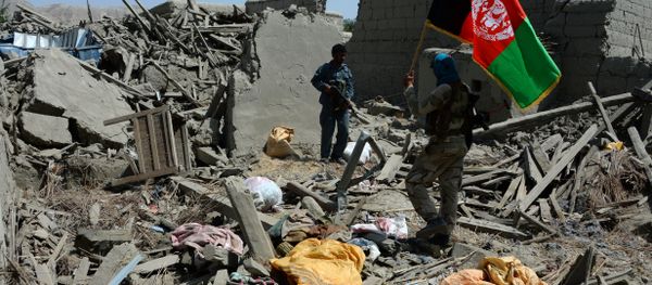 Afghan security force member walks holding the Afghan national flag after government forces took full control of a village from Islamic State (IS) fighters during a military operation in Kot District of eastern Nangarhar province (File) - Sputnik International
