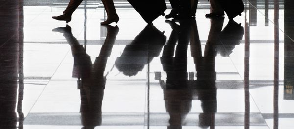 Travellers and their luggage are reflected on the floor at Terminal 3 of Beijing's Capital International Airport. (File) - Sputnik International