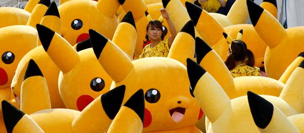 A staff guides performers wearing Pokemon's character Pikachu costumes as they prepare for a parade in Yokohama, Japan A staff guides performers wearing Pokemon's character Pikachu costumes as they prepare for a parade in Yokohama, Japan - Sputnik International
