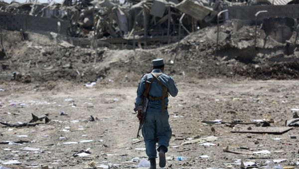 FILE - In this Monday, Aug. 1, 2016 file photo, an Afghan Security policeman inspects the site of a suicide truck bombing, in Kabul, Afghanistan. - Sputnik International