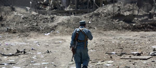 FILE - In this Monday, Aug. 1, 2016 file photo, an Afghan Security policeman inspects the site of a suicide truck bombing, in Kabul, Afghanistan. FILE - In this Monday, Aug. 1, 2016 file photo, an Afghan Security policeman inspects the site of a suicide truck bombing, in Kabul, Afghanistan. - Sputnik International